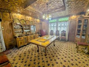 a dining room with a table in a room at Cheetah Palace in Srinagar