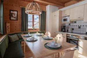 a kitchen and living room with a table and a couch at Astlhof in Grossarl +23 photos