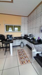 a kitchen with two tables and a rug on the floor at Flat Terra do Sol - Jijoca in Jijoca de Jericoacoara