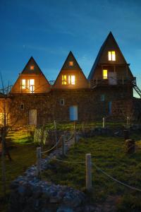 a large stone house with its lights on at night at Black Castle Red Valley in Sevaberd