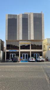 a large building with cars parked in front of it at شقق نيفا المخدومة in Hail