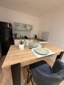 a kitchen with a wooden table with two chairs at Studio moderne tout confort in Vierzon +1 photo