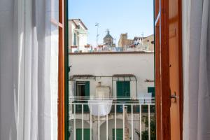an open window with a view of a building at Amalfi mia - city center in Amalfi