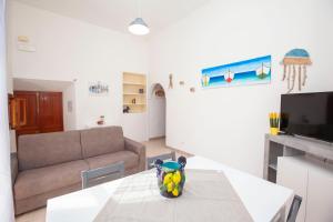 a living room with a table and a couch at Amalfi mia - city center in Amalfi