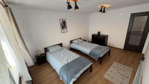 a bedroom with two beds and a mirror at My Central Home in Miercurea-Ciuc