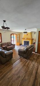a living room with two couches and a fireplace at Pousada Winterhaus in Monte Verde