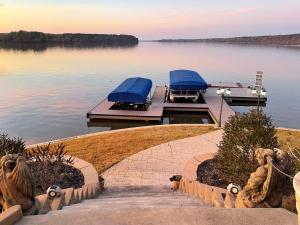 a dock on a lake with a boat in the water at Lake Oconee Waterfront Apartment in Greensboro