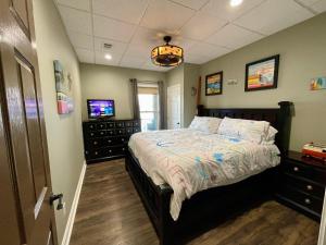 a bedroom with a bed and a television in it at Lake Oconee Waterfront Apartment in Greensboro +19 photos