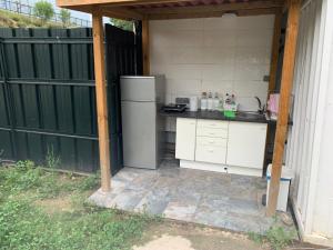 an outdoor kitchen with a refrigerator in a backyard at Yurta cerca de Madrid in Madrid