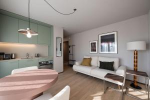 a living room with a couch and a table at Stadtloft Suites Cham-Zug in Cham
