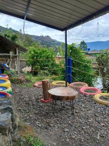 a group of colorful chairs and a table under a tent at Hostal mil colores in Guacamayas