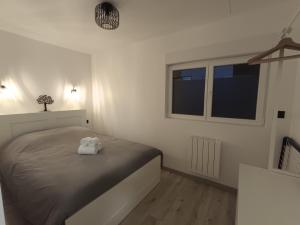 a bedroom with a bed with a towel on it at Chez Mat's & Lou in Rocheville