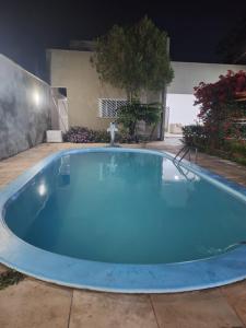 a large blue swimming pool at night at Casa com Piscina px Av Holandeses a 2km da Praia Araçagy in São Luís