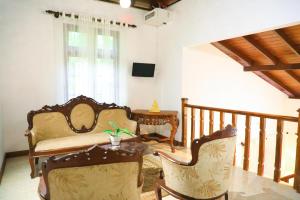 a living room with a couch and a table at Cinnamon River Retreat in Magammana