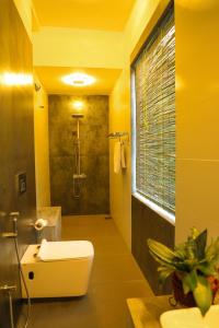 a bathroom with a shower and a toilet and a sink at Cinnamon River Retreat in Magammana +26 photos