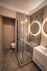 a bathroom with a shower and a toilet and a sink at Apartman VEMY in Trnava