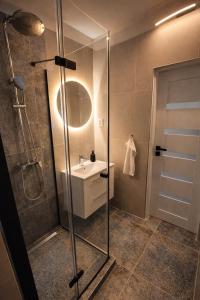 a bathroom with a shower and a sink at Apartman VEMY in Trnava