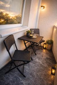 a small table and chairs in a room with a window at Apartman VEMY in Trnava