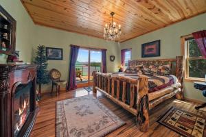 a bedroom with a large bed and a wooden ceiling at Cozy Cabin Style Lake House w Theatre Room & Dock in Sevierville