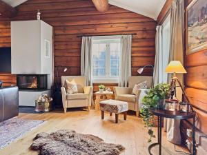 a living room with wooden walls and wooden floors at Mountain Lodge with Jacuzzi & Views in Aurdal