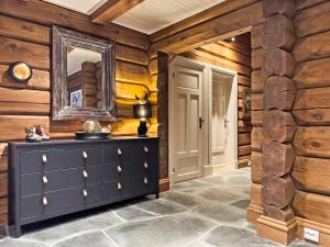 a room with a dresser and a mirror on a wall at Mountain Lodge with Jacuzzi & Views in Aurdal +40 photos