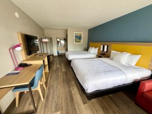a hotel room with two beds and a desk at Park Inn by Radisson, Weldon - Roanoke Rapids in Weldon