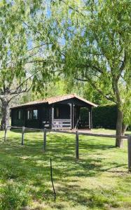 a cabin in the middle of a field with trees at Entrerrobles in Valdeavellano de Tera