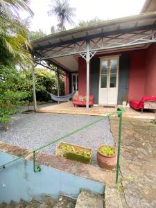 a house with a hammock in front of it at Villa Aruanda in Petrópolis +3 photos