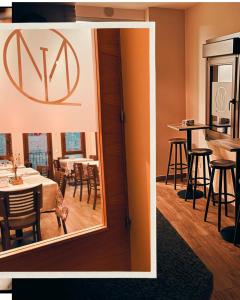 a mirror in a dining room with a table and chairs at Martín Taberna in Villavieja del Lozoya