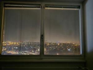 a window with a view of a city at night at welcome geneva in Geneva