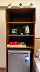 a shelf over a refrigerator with pots and pans at Sheraton Palace Sea View in Alexandria