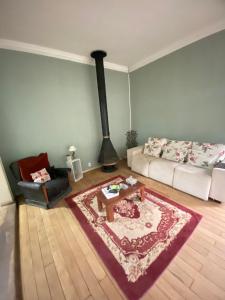 a living room with a couch and a fireplace at Villa Aruanda in Petrópolis