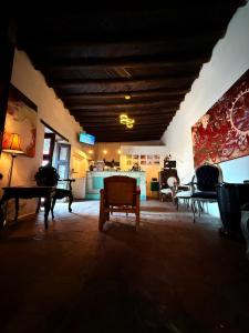 a living room with tables and chairs in a room at Hotel Ruinas Del Real in Real de Catorce