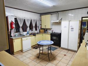 a kitchen with yellow cabinets and a table in it at Jolly Suites in Midrand