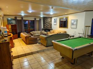 a living room with a pool table in it at Jolly Suites in Midrand