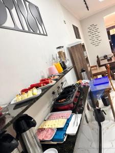 a buffet line with many different types of food at Pousada Akuto's in Aparecida