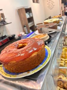a cake sitting on a counter with ayers at Pousada Akuto's in Aparecida +95 photos