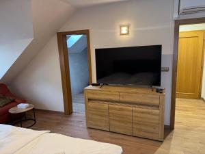 a living room with a large flat screen tv at Pensione Ristorante Moretti in Nitra