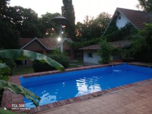 a swimming pool in the yard of a house at Quinta Atalaya in General Rodríguez +15 photos