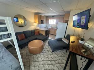 a small living room with a couch and a kitchen at Grand Central Motel in Ely