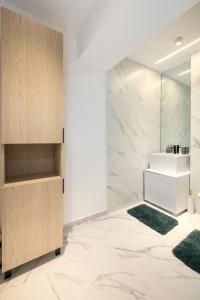 a bathroom with a vanity and a sink at Lila Residence - by Solinis Homes in Bucharest +251 photos
