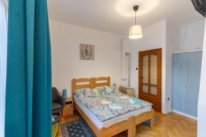 a bedroom with a bed and a desk and a chair at Kispál Apartmanház in Zalakaros