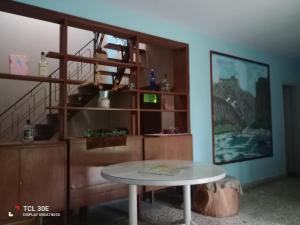 a table in a room with a shelf and a table at Quinta Atalaya in General Rodríguez