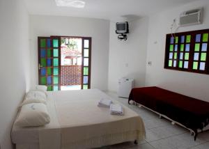 a bedroom with a large bed and a window at Dormitório Dourada Costa in Baía Formosa