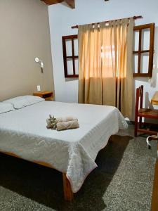 a bedroom with a bed with two towels on it at Casa Josefa Cafayate in Cafayate