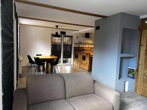 a living room with a couch and a table at Apartamenty 5 i 6 w Karkonoszach in Jelenia Góra