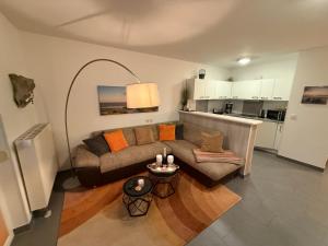 a living room with a couch and a table at Störtebekers Kuschelnest -265 in Sagard