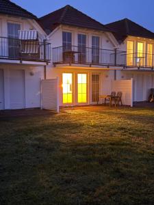 a large house with a lawn in front of it at Störtebekers Kuschelnest -265 in Sagard