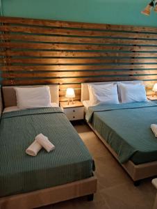 two beds sitting next to each other in a bedroom at Litsa's House Platanias in Agia Paraskevi