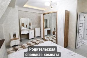 a bathroom with two sinks and two mirrors at Gagarin Luxury Apartment in Samarkand +5 photos
